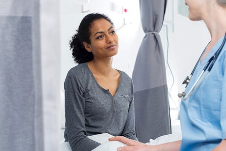 Nurse discussing cervical cancer with a patient.